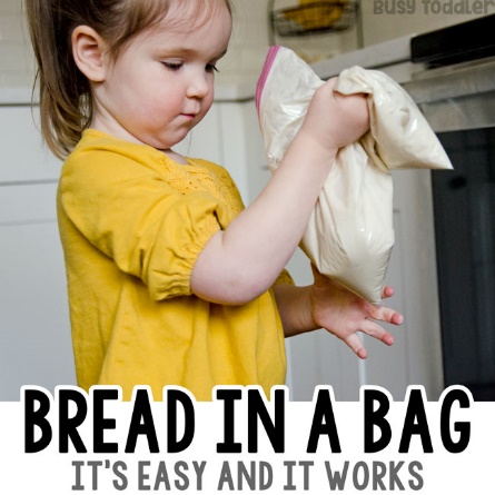 A child holding a bread in a bag