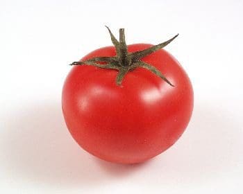 A tomato is sitting on the table